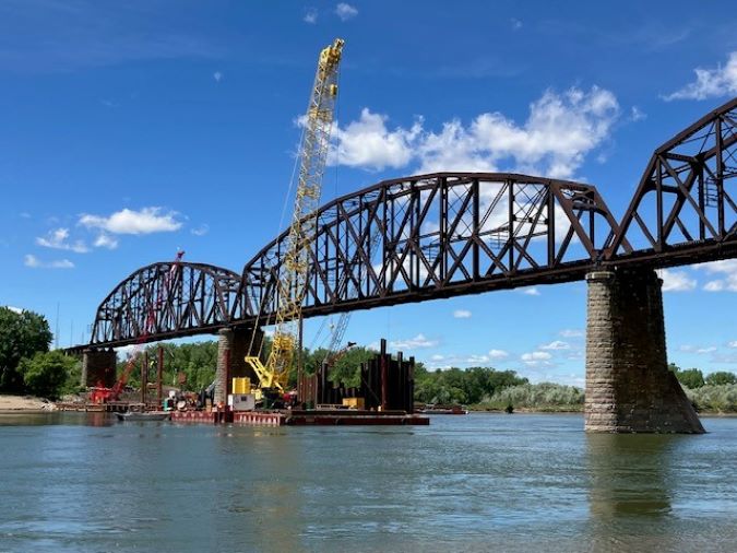 Construction of the new bridge’s piers begins next to the existing bridge.